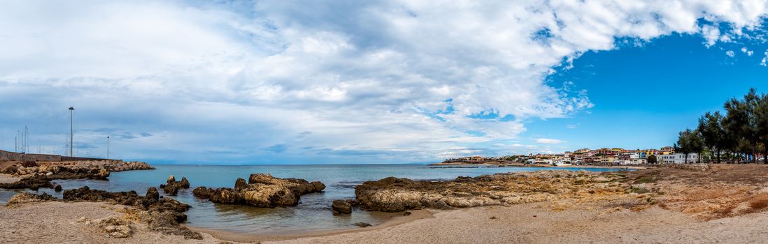 View of the beach inside the city of Porto Torres in a cloudy day of autumn