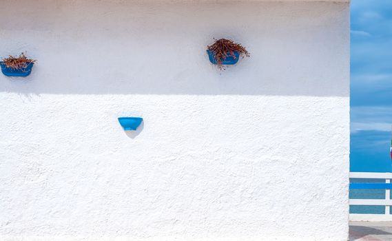 White and blue building on the beach in a cloudy day of autumn - Platamona - Sardinia - Italy