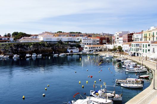 Es Castell Harbor, Traditional Houses and Lagoon on Blue Skies background, Menorca, Balearic Islands