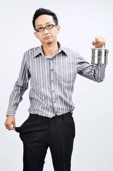 Portrait of sad Asian businessman with empty pocket, hand hold his home cook lunch box, standing isolated on plain background.
