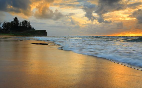 Views north looking across Little Austinmer beach to Brickyard Point at sunrise