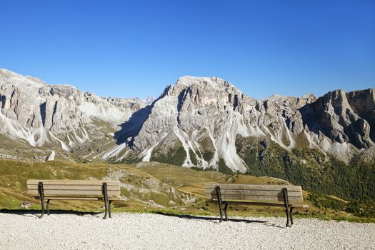 Mountain view of Dolomite Alps with empty benches in the foreground