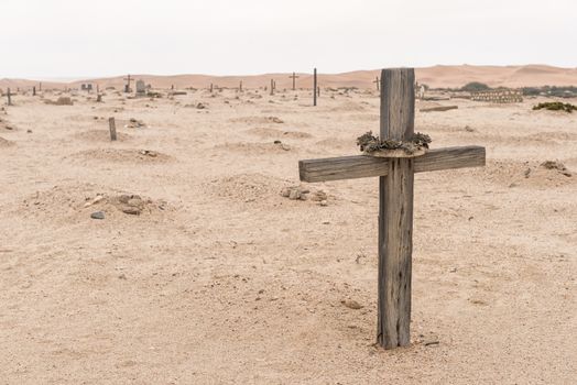A grave in the historic Herero cemetery in Swakopmund in the Namib Desert on the Atlantic Coast of Namibia. Sand dunes are in the back