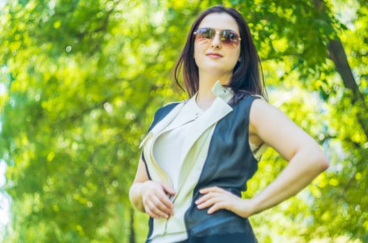 young caucasian business woman in stylish clothes in the park