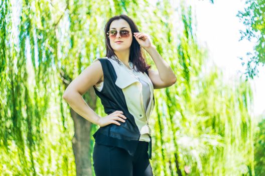 young caucasian business woman in stylish clothes in the park