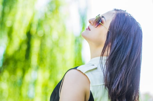 woman in stylish clothes walking in the park