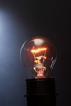 Closeup of one glowing lamp against dark background