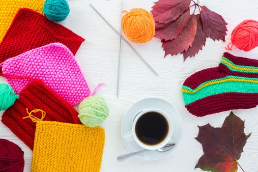 Autumn knitting with a mug of coffee on a white background