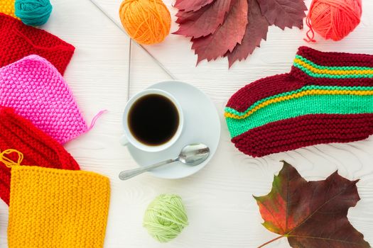 Autumn knitting with a mug of coffee on a white background
