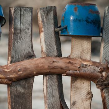 Old wooden boundary fence with nails on sunny day