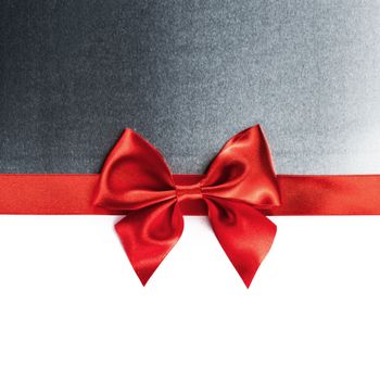 Red gift ribbon bow and metal isolated on white background