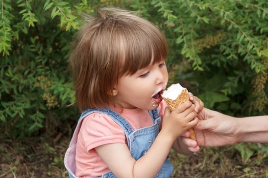 Photo of cute girl are eating icecream in summer time