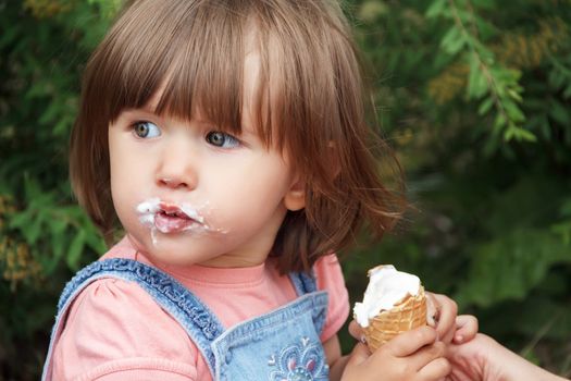 Photo of cute girl eating icecream in summer