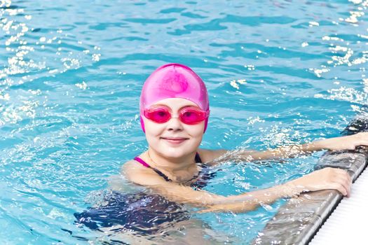 Photo of cute girl in swimming pool