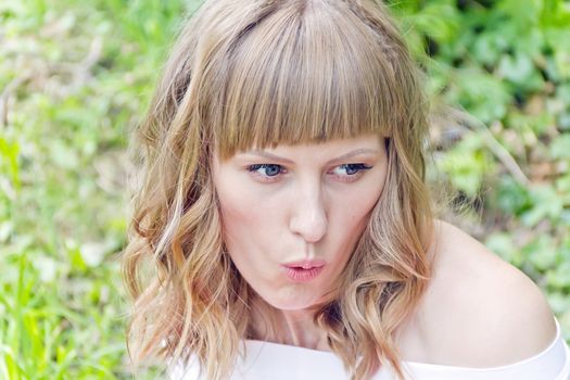 Portrait of beautiful talking girl on green background