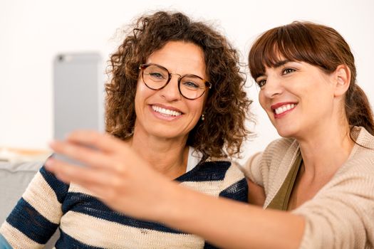 Two beautiful firends at home making  a selfie