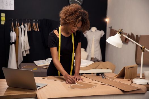 A young fashion designer working on her atelier