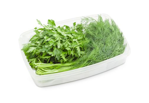 Bundles of the freshly harvested dill and parsley in white plastic container on a white background
