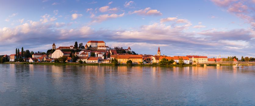 Ptuj, Slovenia, panoramic shot of oldest city in Slovenia with a castle overlooking the old town from a hill and the Drava river beneath