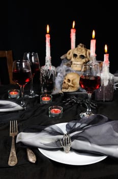 Napkin with a clip in the form of a skeleton of a brush as an element of a decor of a holiday table for Halloween