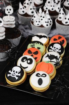 Halloween biscuits sandwich with colorful decorated with marzipan baked for the holiday
