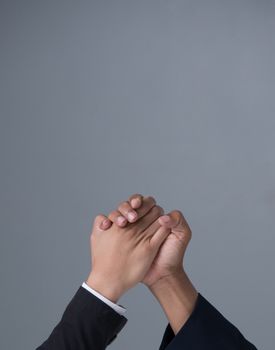 businessman engaged in arm wrestling  on gray background