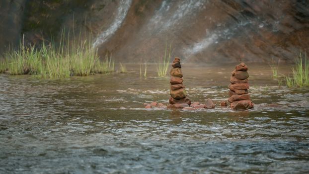 Pebble stones over waterfall , zen like concepts.