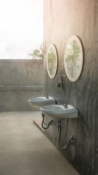 a white sinks and a stylish mirror