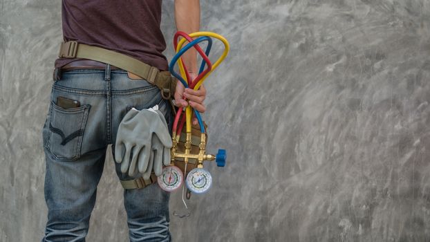 Man's hand holding a manometers on equipment for filling air conditioners with copy space background