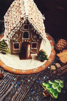 Gingerbread house with lights on dark background, xmas theme