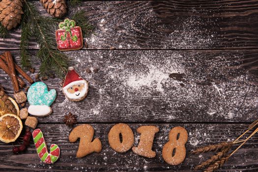 Different ginger cookies for new 2017 year holiday on wooden background, xmas theme