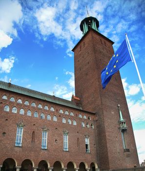 Stockholm City Hall ( Stockholms stadshus) with EU flag in Stockholm, Sweden