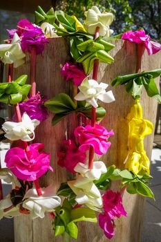 Traditional polynesian flower necklace on a wooden background