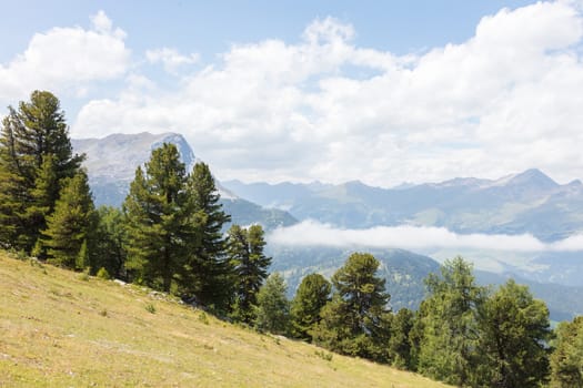 View of beautiful landscape in the Alps - Clouds rolling past the mountains