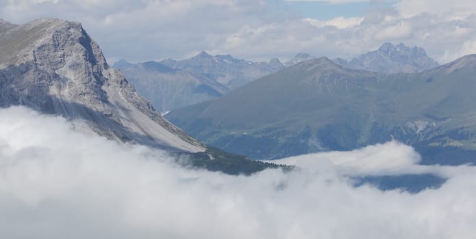 View of beautiful landscape in the Alps - Clouds rolling past the mountains