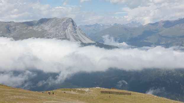 View of beautiful landscape in the Alps - Clouds rolling past the mountains