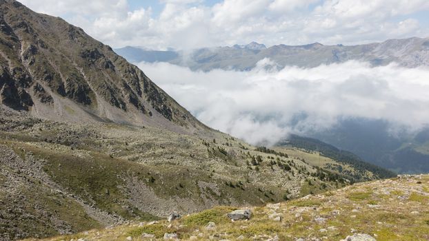 View of beautiful landscape in the Alps - Clouds rolling past the mountains