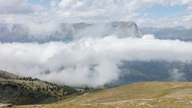 View of beautiful landscape in the Alps - Clouds rolling past the mountains