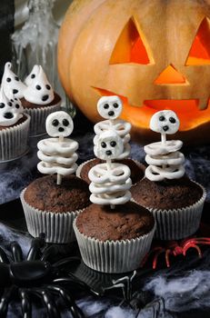 skeleton of pretzels in milk chocolate and marshmallow in a muffin, on a table in honor of Halloween