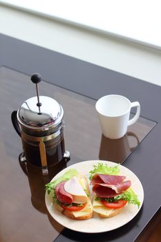 Healthy breakfast with sandwiches and coffee in french press, scandinavian style