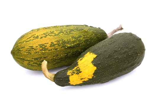 Two large warty ornamental gourds, green ripening to orange and with a yellow patch, isolated on a white background