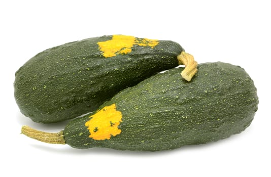 Two large marrow-shaped warty ornamental gourds, deep green with orange patches, isolated on a white background