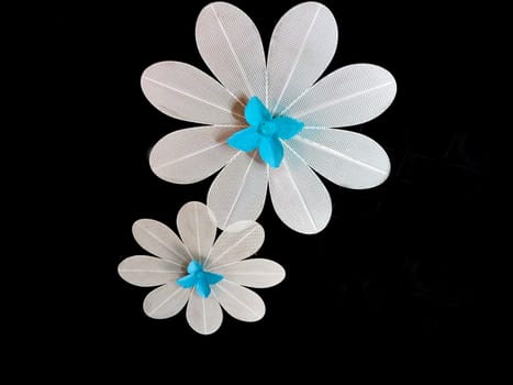 2 metal flowers with a black background