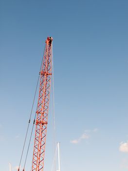 red crane top reaching into the blue sky above; essex; england; UK