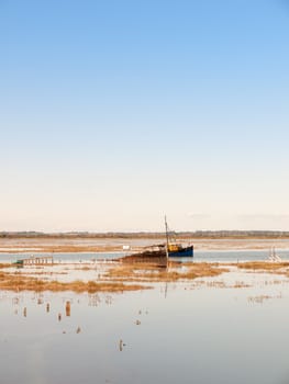 boat moving through estuary river stream with plenty of water space; essex; england; UK