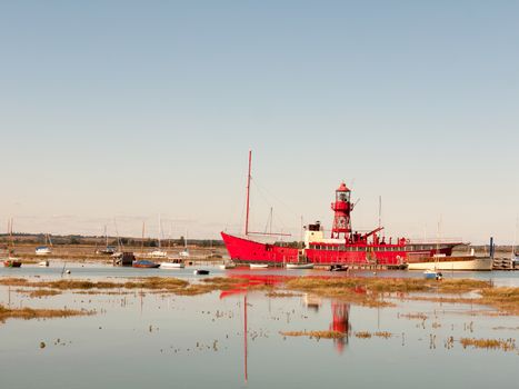 big red life boat moored in tollesbury estuary sunny day; essex; england; UK