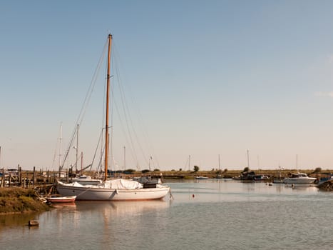 white yacht boat moored in dock of marshland tollesbury maldon; essex; england; UK