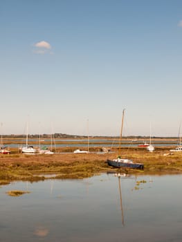 boats parked in stream river estuary in tollesbury maldon essex; essex; england; UK