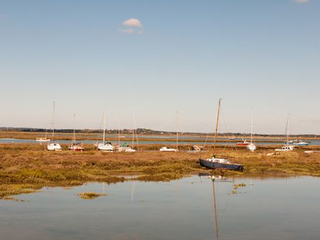 row boats parked in stream river estuary in tollesbury maldon essex; essex; england; UK