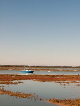 estuary scene river with boats traveling through sunny day; essex; england; UK